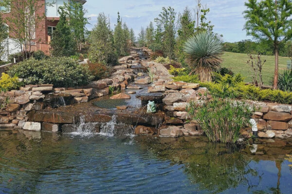 A photo of a landscape design project with a waterfall feature.